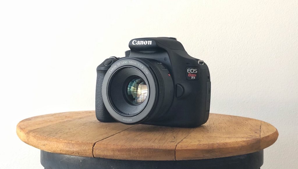 Canon EOS rebel t5 dslr camera on wooden table