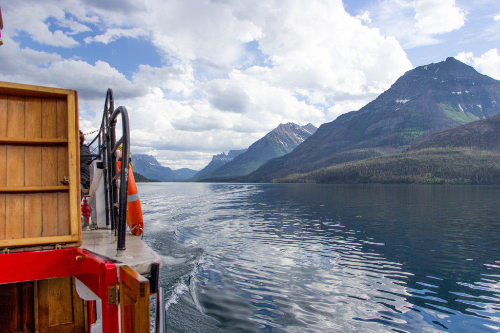 view from boat of mountains and waterton lake in alberta canada