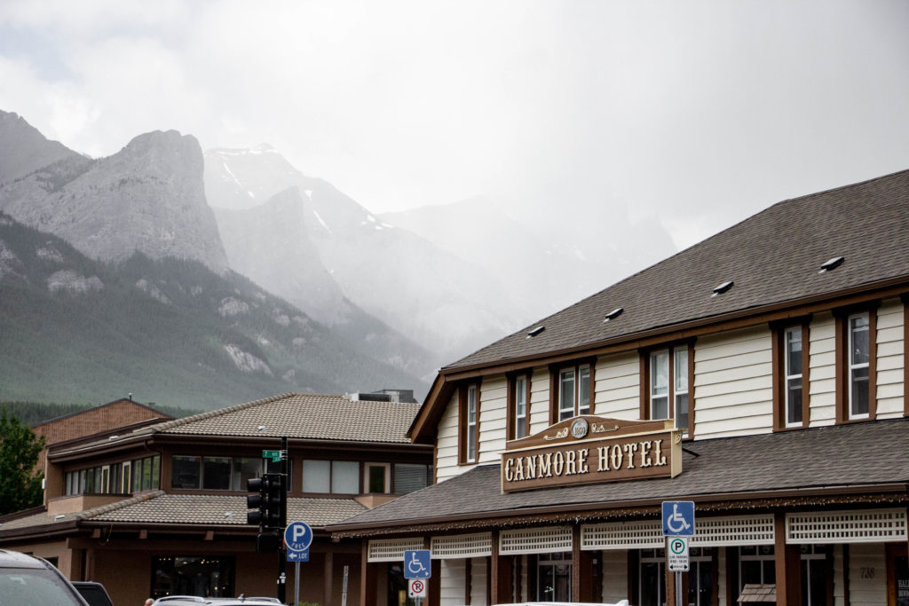 Canmore Hotel in front of foggy mountains