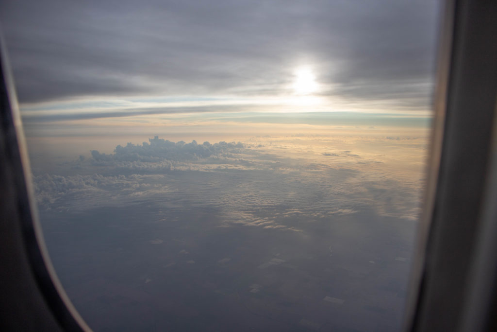 Sunrise view from airplane with clouds