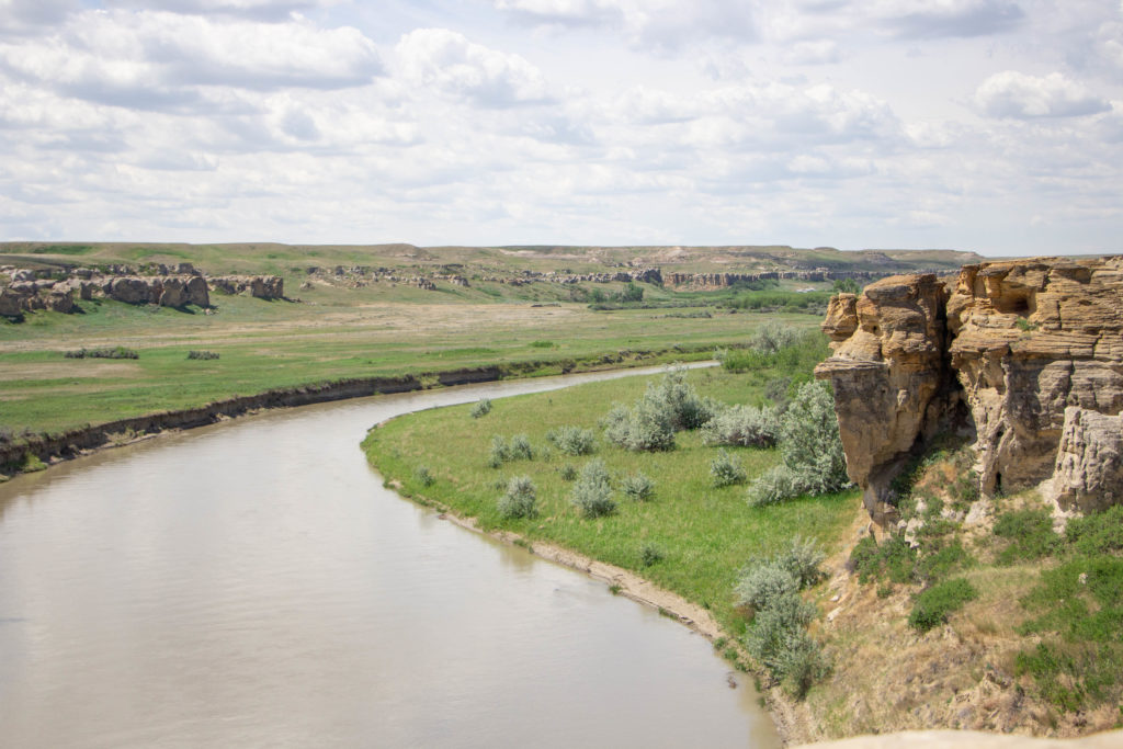 Milk river and green grass in writing on stone provincial park in alberta canada