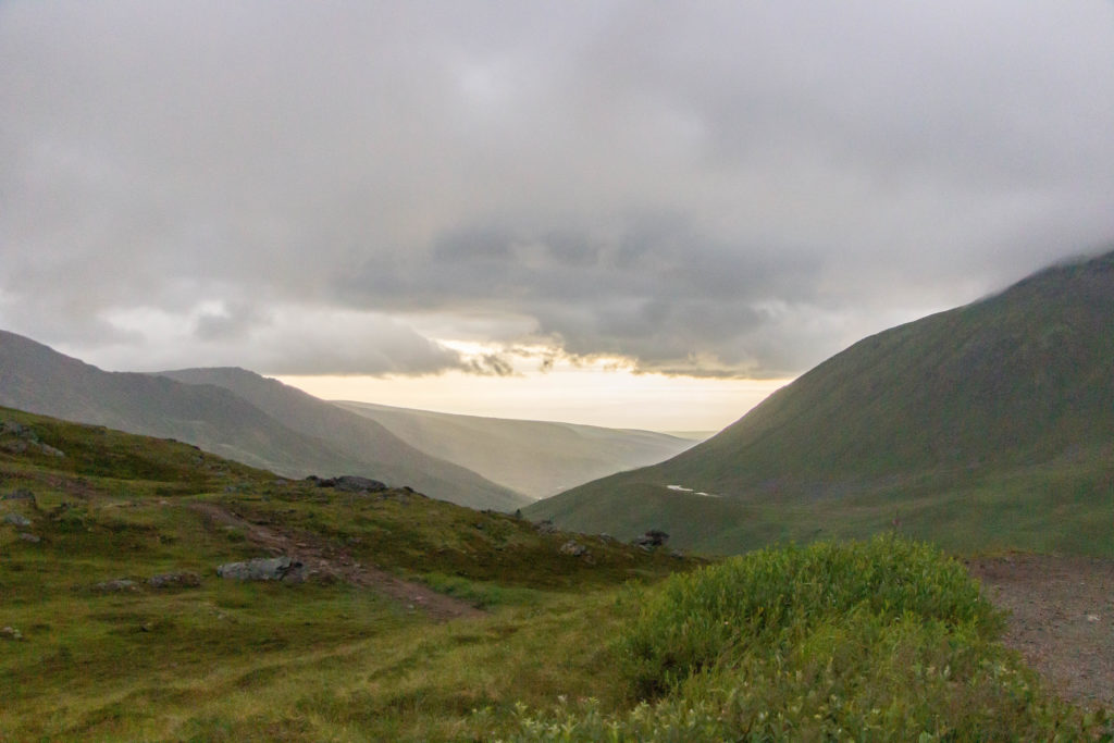 Sunset with gray clouds over green hills at hatcher pass summit near anchorage alaska