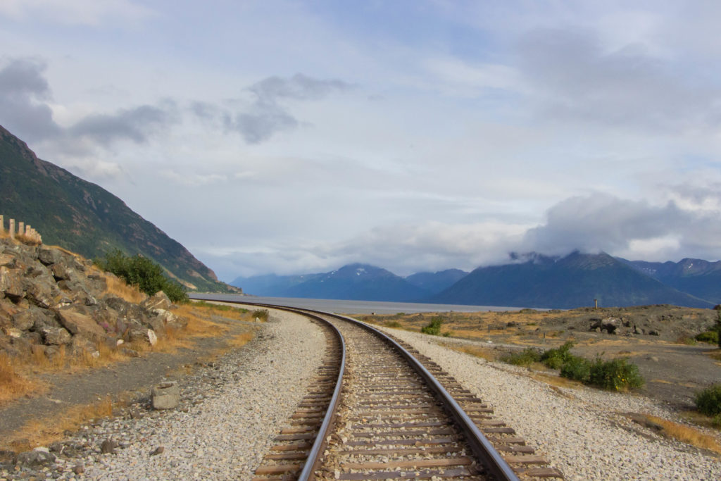 Railroad tracks in alaska turnagain arm seward highway with mountains