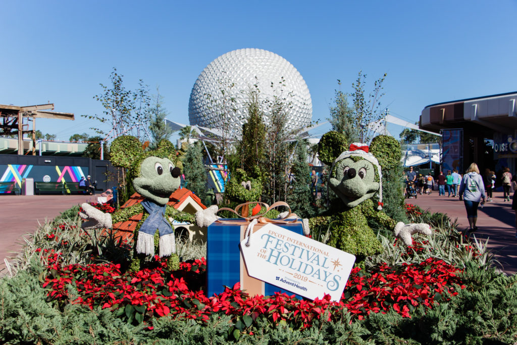 mickey and Minnie Mouse topiary in front of spaceship earth during festival of holidays at Epcot Disney World Christmas time