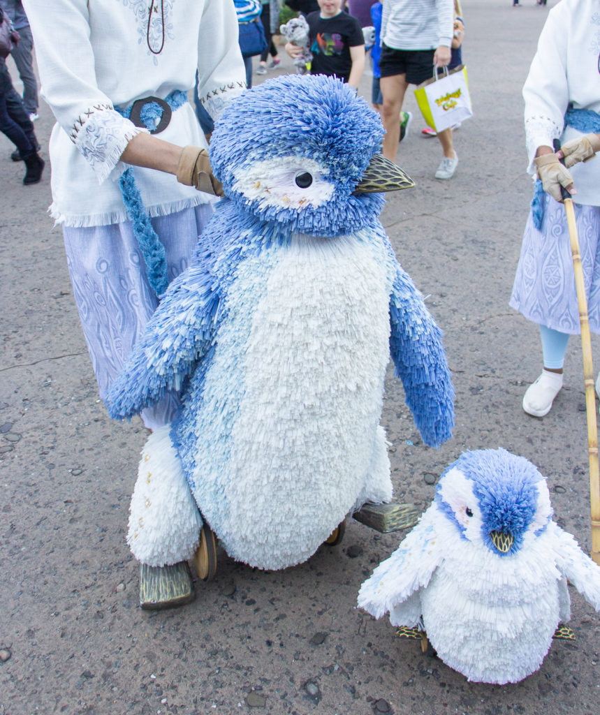 mother and baby penguin holiday puppets in animal kingdom park Disney World Christmas time