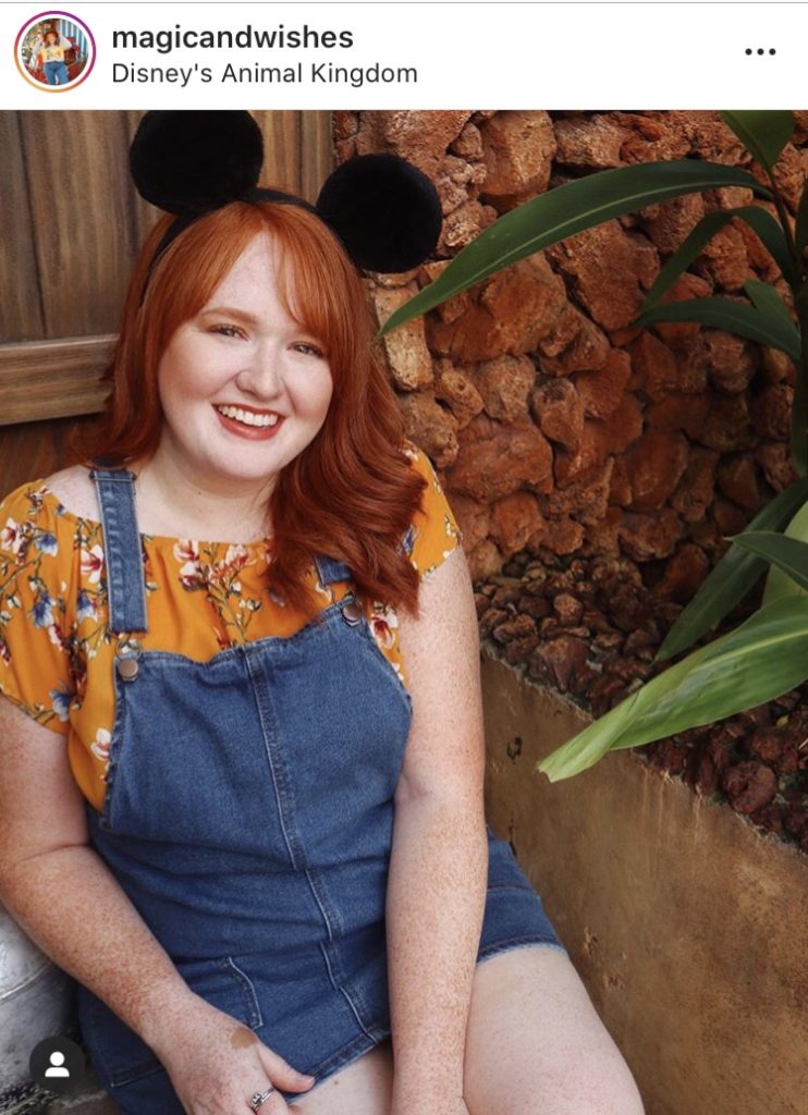red head girl with mickey ears and overalls and yellow shirt magic and wishes