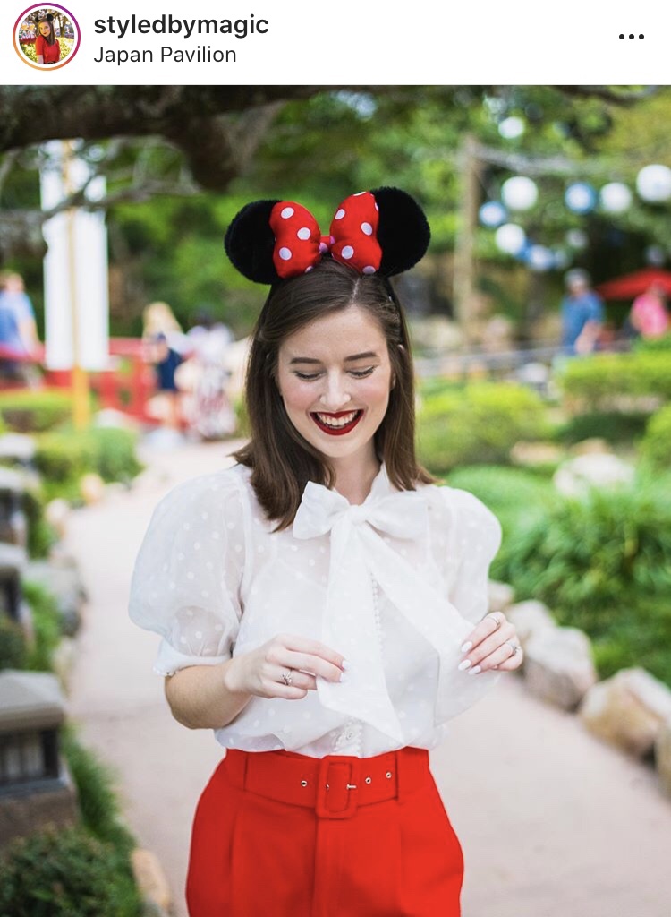 styled by magic girl with white blouse, red pants, and minnie ears in garden