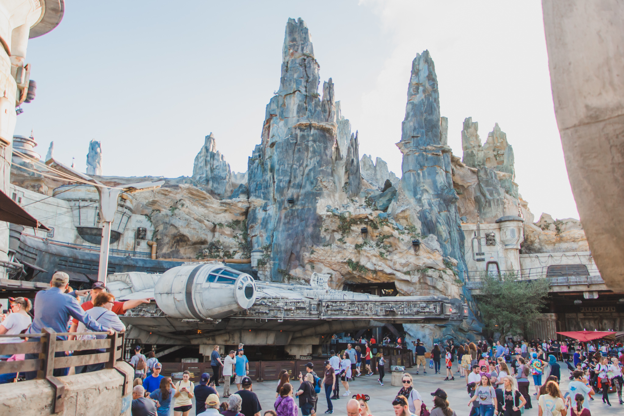Millenium Falcon with crowds and spires at Star Wars galaxy's edge Disney World Hollywood Studios Orlando Florida