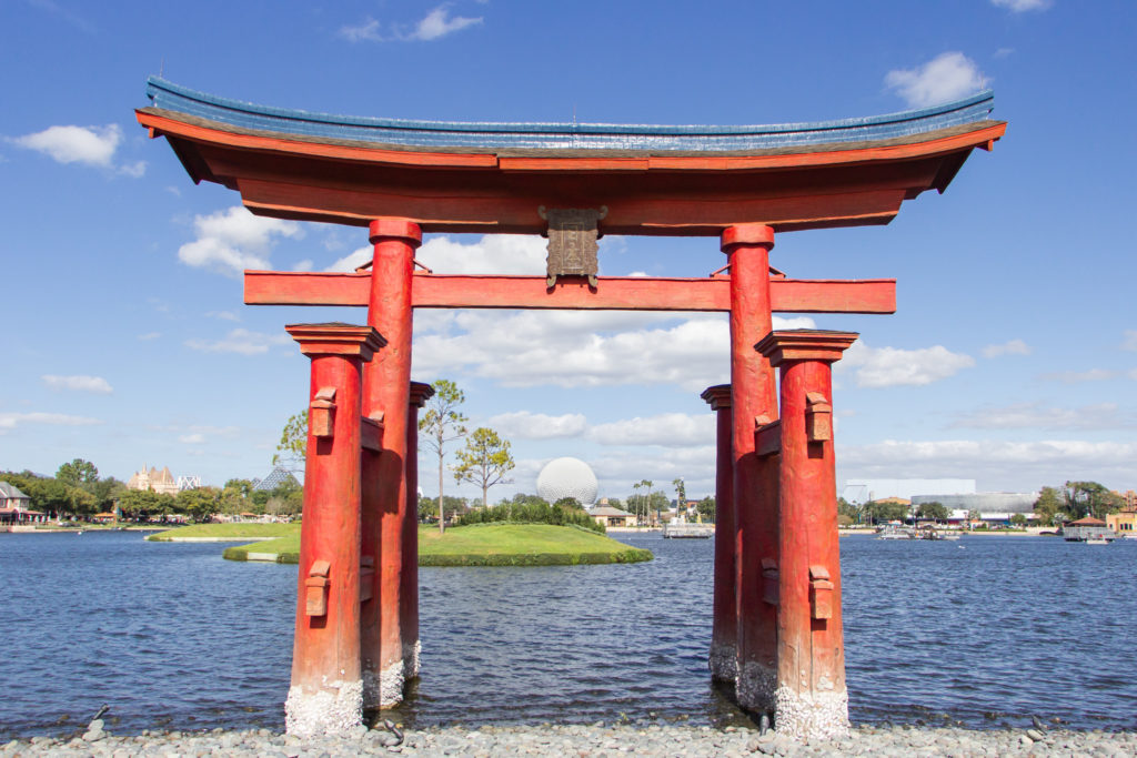 Japanese torii gate with spaceship earth at Epcot Disney World Orlando Florida red arch at Japan Pavillion
