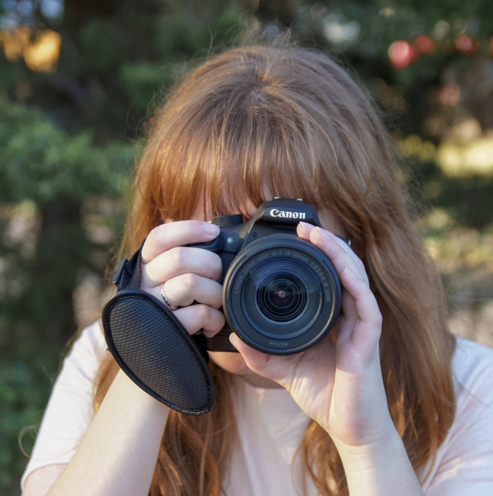 girl with red hair with canon rebel t5 camera dslr outside photography