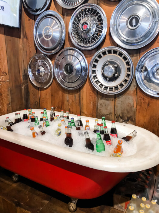 Day Trip to Long Beach, Mississippi - Red bathtub with soda bottle and hubcaps at Ed's Burger Joint in Hattiesburg Mississippi