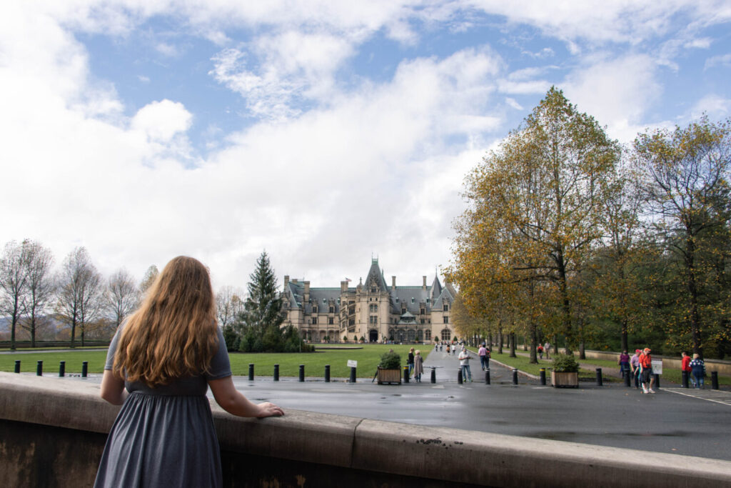 Why You Should Visit the Biltmore Estate at Christmas Time - Girl standing in front of the Biltmore Estate