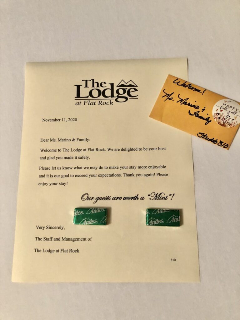 Things to Do on a Day Trip to Flat Rock, North Carolina - The Lodge at Flat Rock personalized welcoming note with mints on the bed